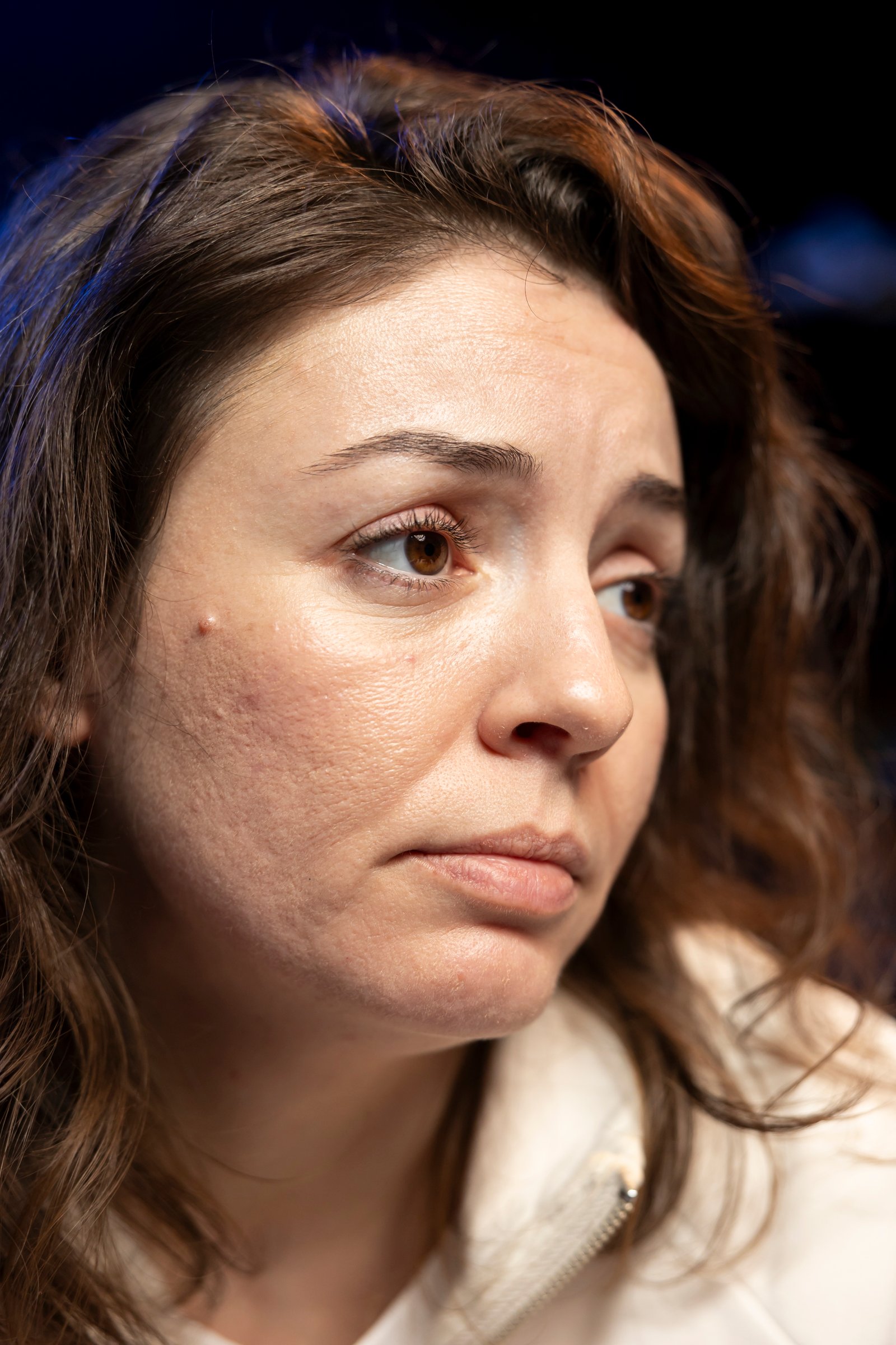 Woman examining thinning hair with concern