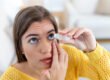 Woman using lubricating eye drops for dry eyes