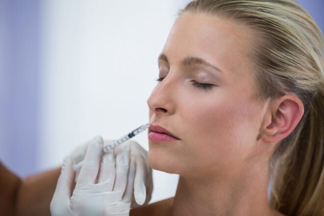 Chin Botox Orange Peel Chin Photo Woman receiving a precise Botox injection in the lower face to smooth chin dimpling