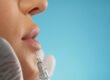 Injector placing a small Botox dose near the upper lip to soften vertical lip lines