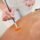 Provider brushing a chemical peel onto a woman's back to treat back acne and dark marks at PURE Medical Spa Chicago