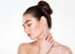 Woman touching the smooth, even toned skin of her neck after a chemical peel for neck discoloration