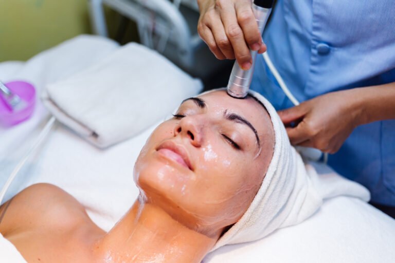 Client relaxing during a full facial, a step up from dermaplaning alone
