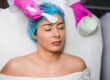 Aesthetician applying a soothing mask to a relaxed client during a facial