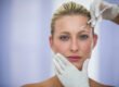 Woman receiving a neuromodulator injection between the brows for frown lines