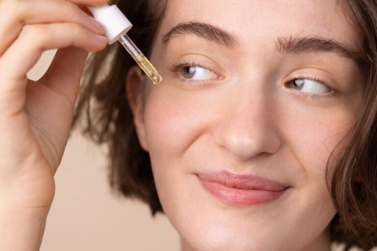 Hyperpigmentation Treatment After Brightening Serums Smiling woman applying a brightening serum before choosing her next hyperpigmentation treatment