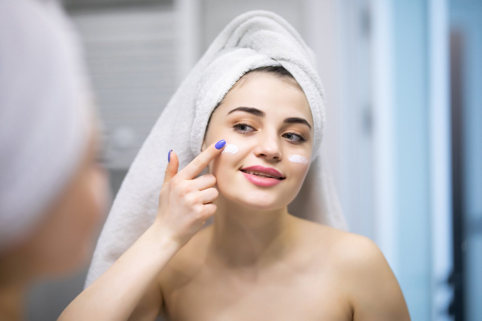 Hyperpigmentation Treatment for Sensitive Skin Smiling woman applying a gentle cream as part of hyperpigmentation treatment for sensitive skin