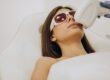 Client in protective eyewear having laser hair removal for upper lip hair