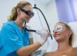 Smiling woman receiving laser hair removal on her face for PCOS and hormonal facial hair at PURE Medical Spa Chicago