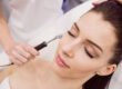 Smiling woman receiving facial laser hair removal along the jawline at a Chicago med spa