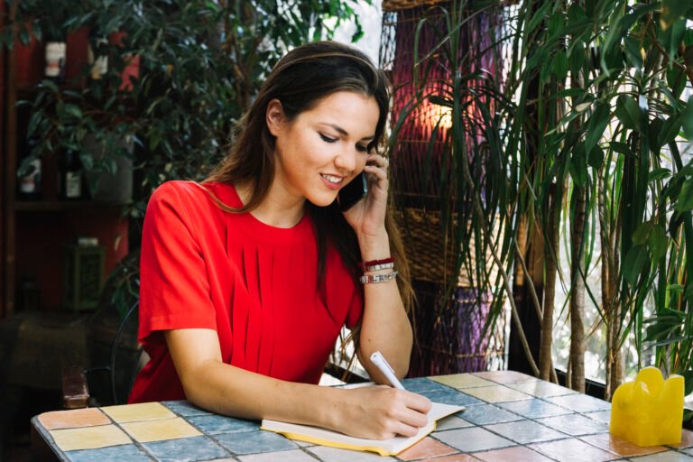 Rescheduling a Missed Sculptra Session in Chicago Woman rescheduling her Sculptra appointment by phone and noting the new date in her planner