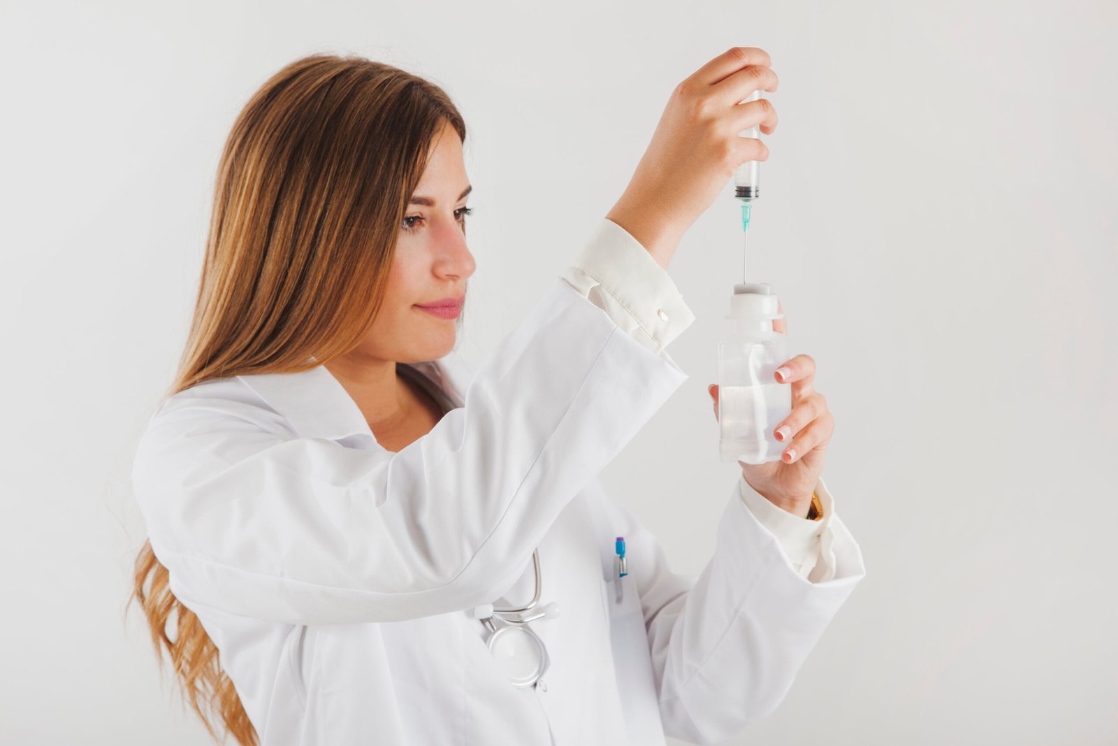 Provider preparing a peptide injection from a vial