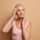 Confident mature woman touching her smooth cheeks after Sculptra collagen treatment for menopause volume loss in Chicago