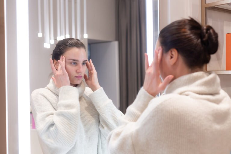 Sculptra During Weight Loss in Chicago Woman checking facial volume in a mirror while planning Sculptra during weight loss
