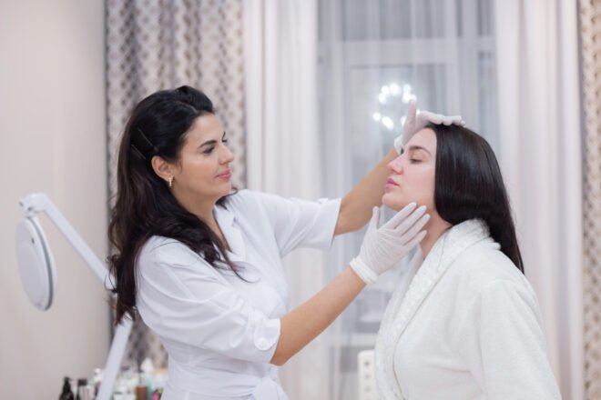 Aesthetic provider consulting with a smiling client about skin hydration treatment