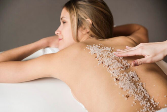 VI Peel for Body Acne in Chicago Woman receiving a body peel treatment on her back for body acne on the back and shoulders at PURE Medical Spa Chicago