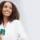Smiling woman holding a VI Peel treatment kit, comparing VI Peel and IPL for pigmentation and sun spots in Chicago